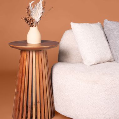 bouclé sofa and wooden side table with vase