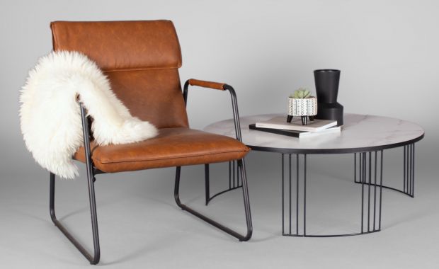 contemporary leather chair with sheepskin throw and modern coffee table with marble top