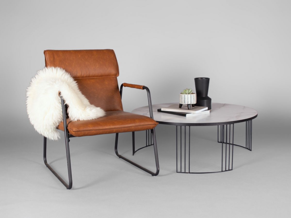 contemporary leather chair with sheepskin throw and modern coffee table with marble top