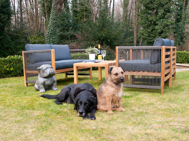 Milos collection - outdoor furniture hire in a garden with 2 dogs sat in front