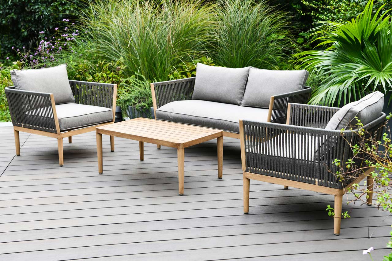 Delphi Outdoor furniture hire - grey fabric with oak wood legs on grey decking with green plants in the background